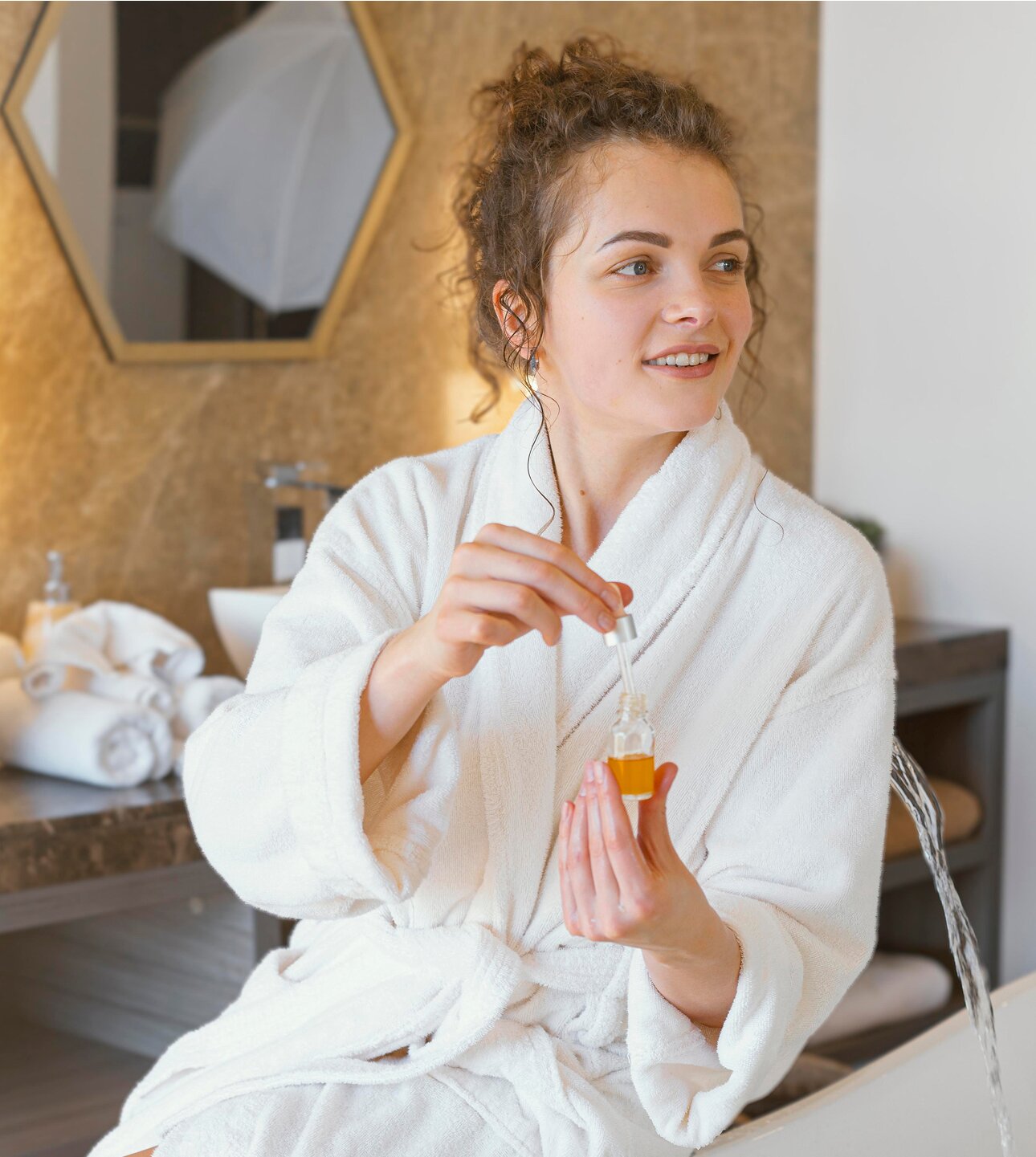 Woman applying a nourishing botanical facial serum